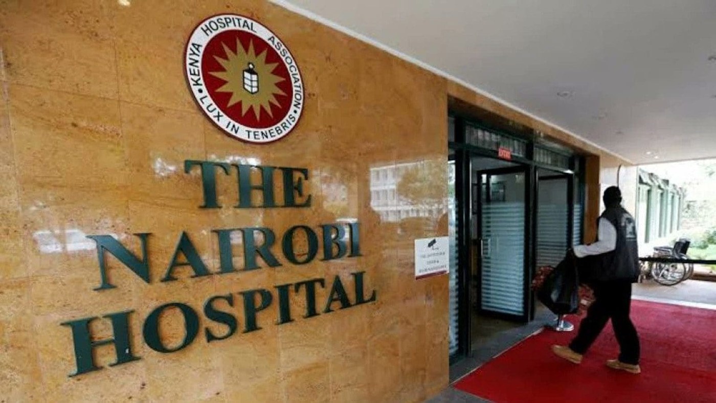 The entrance to The Nairobi Hospital, with the hospital's name and crest on a stone wall.