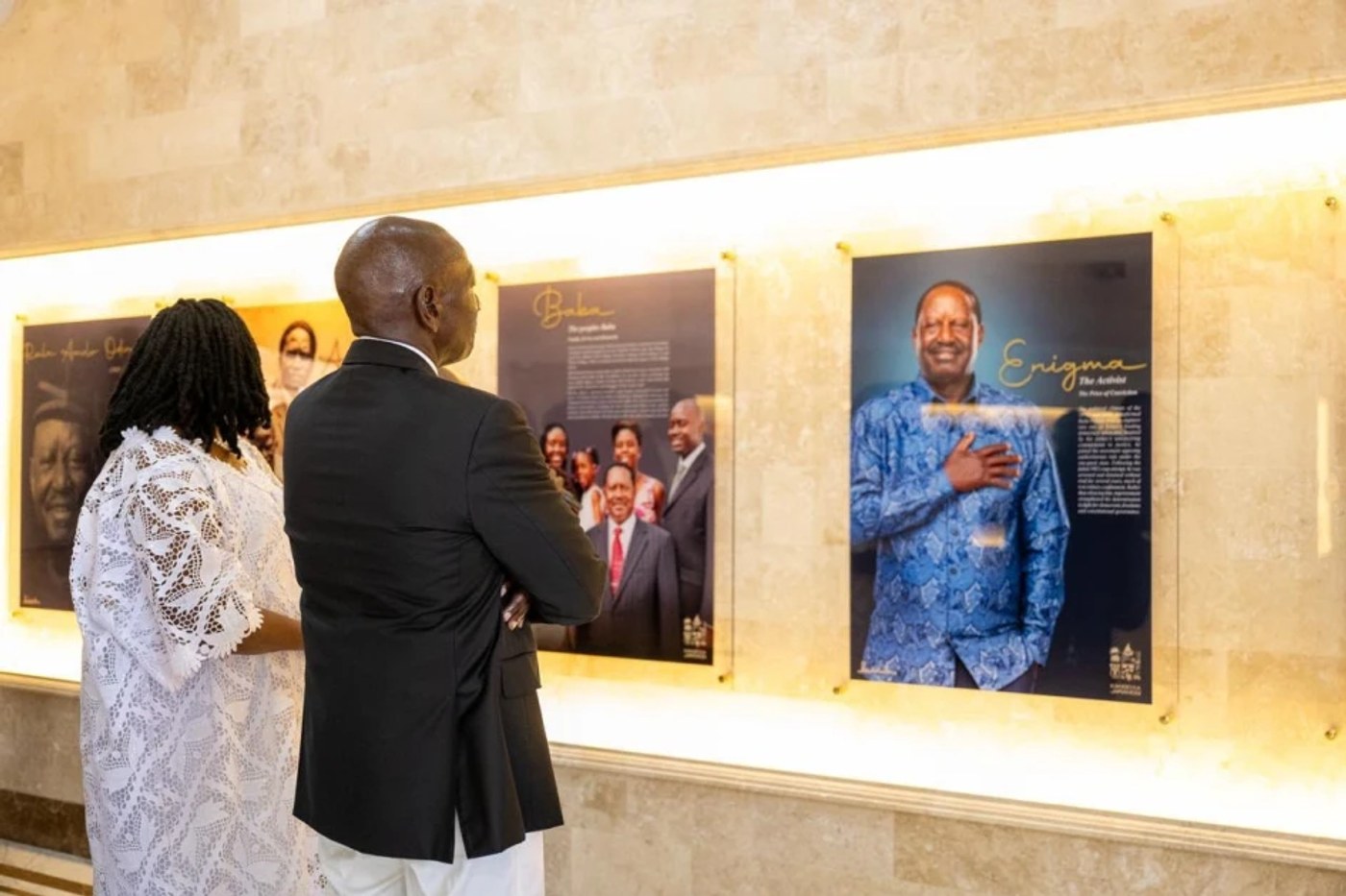 President William Ruto, seen from behind, views a photo display about Raila Odinga inside the mausoleum at Kang'o ka Jaramogi.