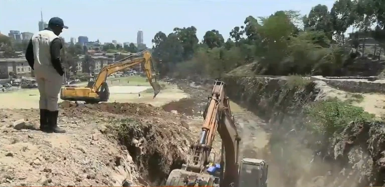 Excavators work beside a channel at Nairobi Dam.