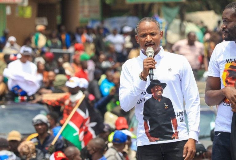 Babu Owino speaks into a microphone above a crowd at Marikiti Market.