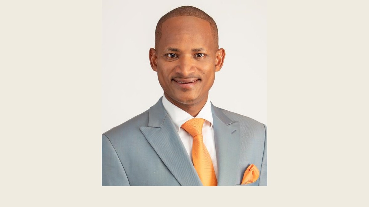 Babu Owino in a grey suit and orange tie in his official parliamentary portrait.